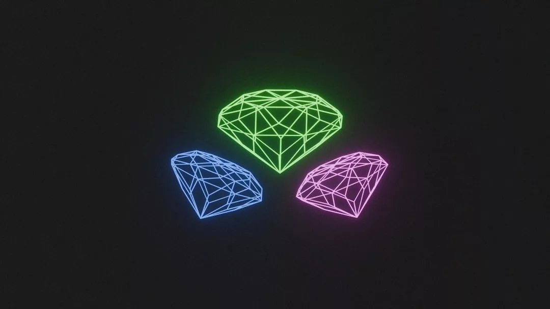 Three neon wireframe diamond shapes—one green, one blue, and one pink—glow against a black background, evoking a sense of modern luxury and sophistication.