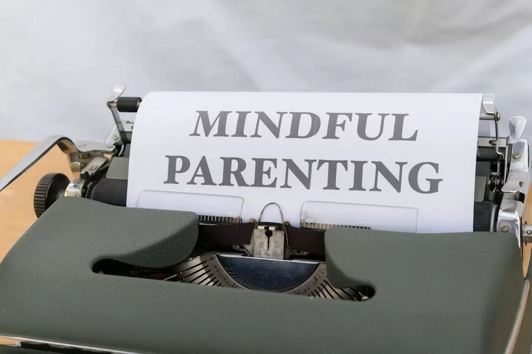 A typewriter with a sheet of paper that reads "Mindful Parenting" in large, bold letters—a glimpse into a lifestyle focused on intentional family moments.