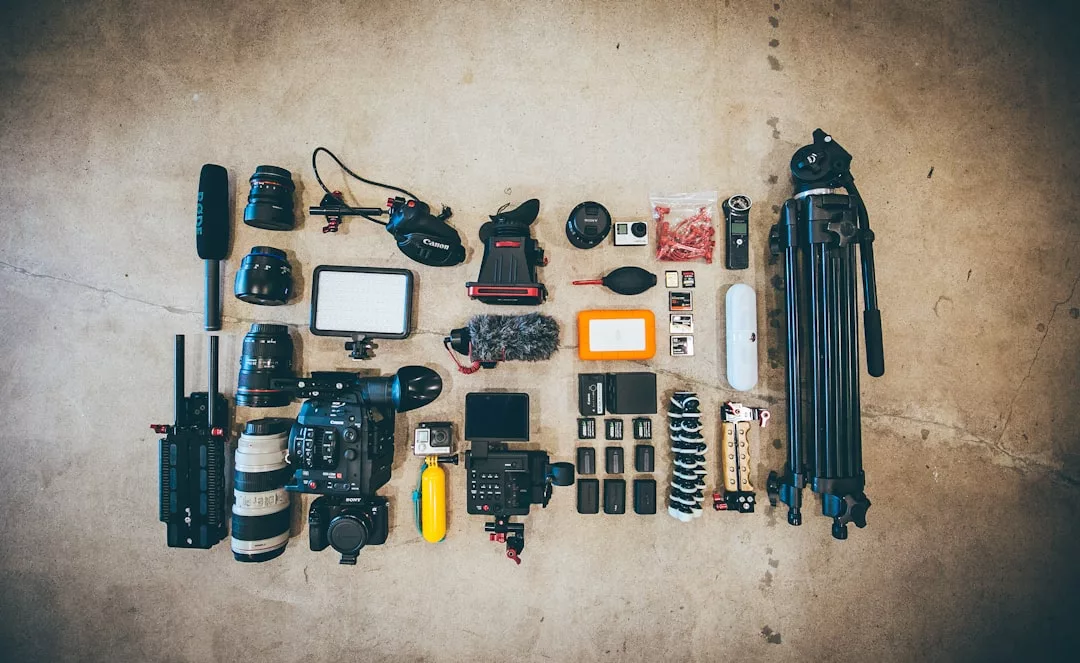 Camera equipment, including cameras, lenses, tripods, microphones, and more, arranged neatly on a concrete floor—perfect for capturing a luxury lifestyle or Glamesia-inspired moments with style and precision.