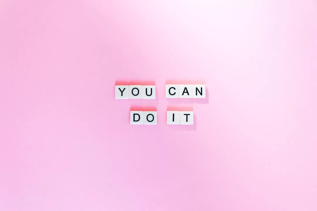 Letter tiles on a pink background spell out the phrase "You can do it," adding a touch of lifestyle inspiration to your day.