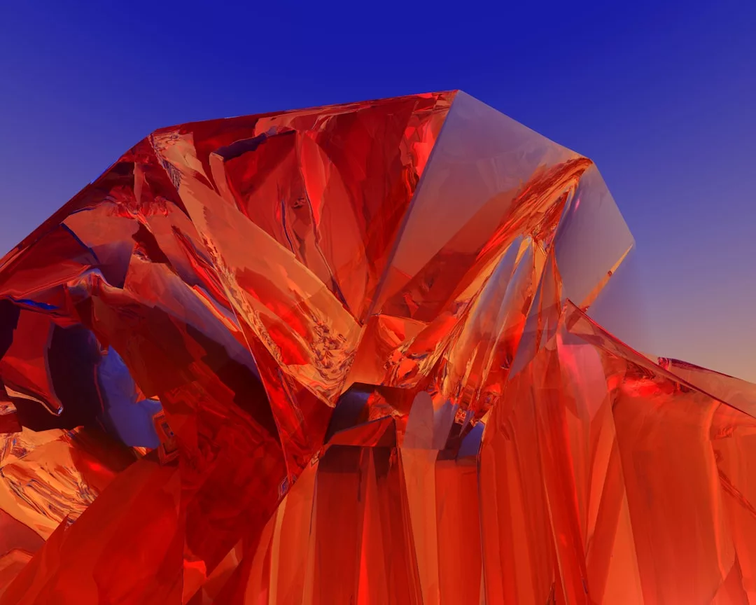 A large, angular, translucent red crystal structure stands against a gradient blue to orange sky, radiating an aura of modern luxury.