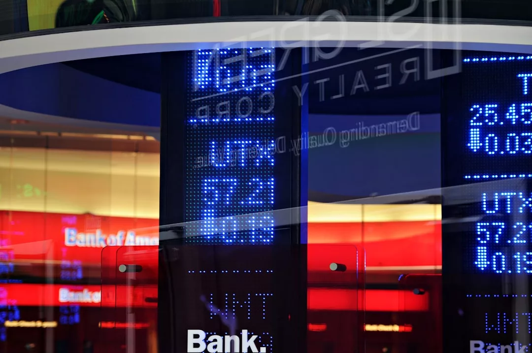 Digital display showing financial data and exchange rates, with reflections of Bank of America signage and colorful lights in the background, capturing a sense of Glamesia-inspired fashion and urban laxary.