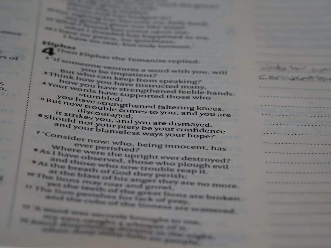 A close-up of an open Bible page showing Job 4:4-7, with some verses highlighted in bold and a lined note section on the right, blending spiritual wisdom with a touch of lifestyle elegance.