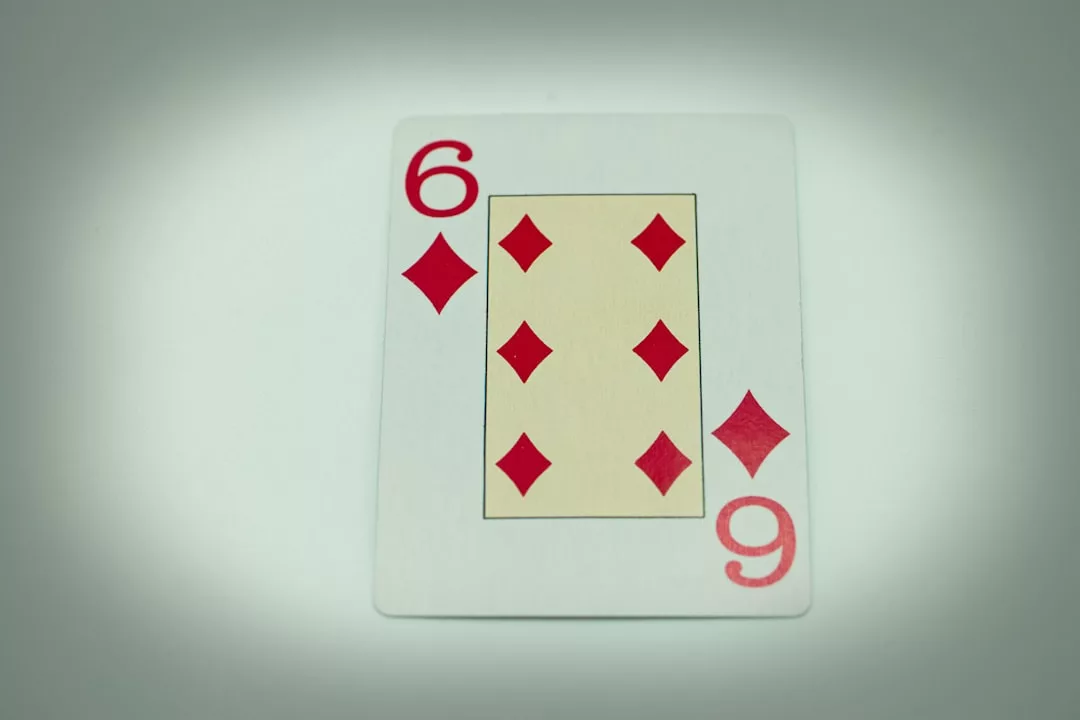 A Glamesia playing card showing the six of diamonds, with six red diamond shapes and the numbers 6 in the corners—perfect for adding a hint of lifestyle elegance to your next game night.