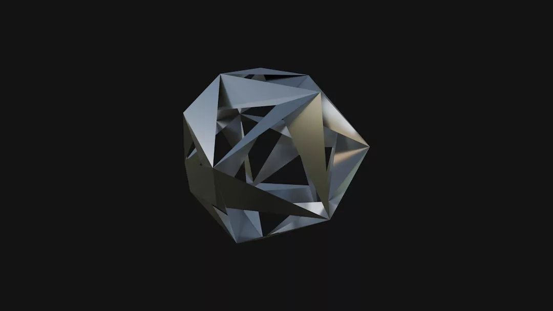 A metallic, 3D geometric shape with triangular facets exudes luxury as it is displayed against a dark background.
