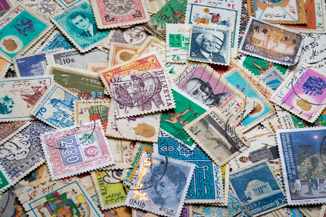 A scattered assortment of vintage postage stamps from various countries, featuring different colors, designs, and denominations—a unique touch of lifestyle luxury for discerning collectors.