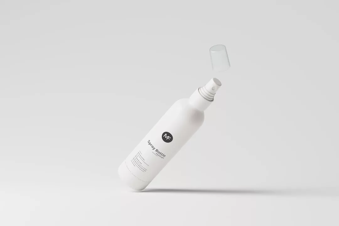A white spray bottle labeled "WF Spray Bottle" floats against a light grey background, its transparent cap suspended above—perfect for adding a touch of luxury to your modern lifestyle.