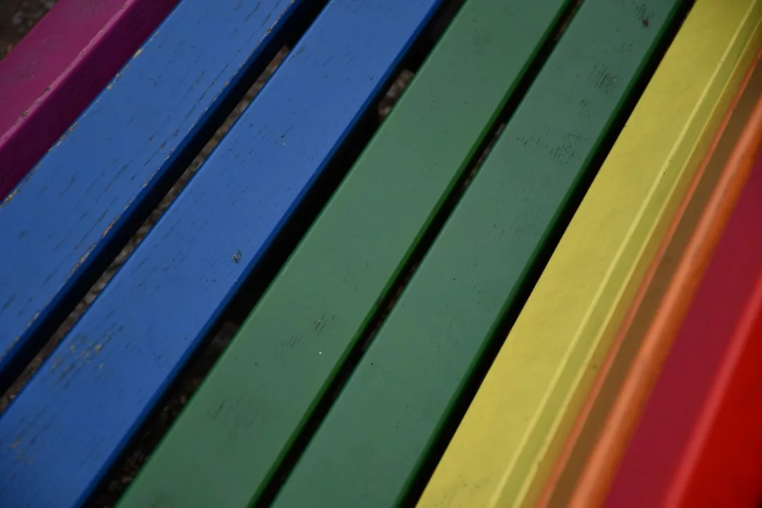 Close-up of wooden planks painted in blue, green, yellow, and orange arranged diagonally, adding a touch of luxury to your lifestyle.