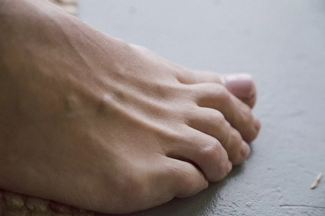 A close-up view of a human foot resting on a flat surface, highlighting toes and part of the top of the foot, embodies a relaxed lifestyle moment.