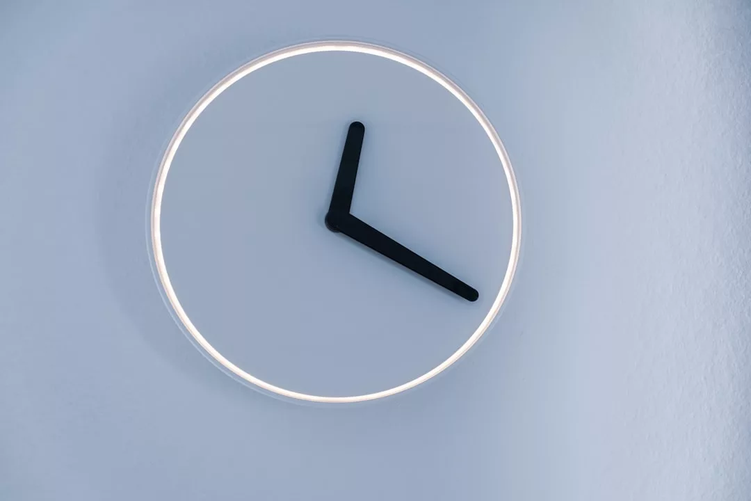 Minimalist Glamesia wall clock with a white face, no numbers, and black hour and minute hands showing 10:10—perfect for elevating your modern luxury lifestyle.