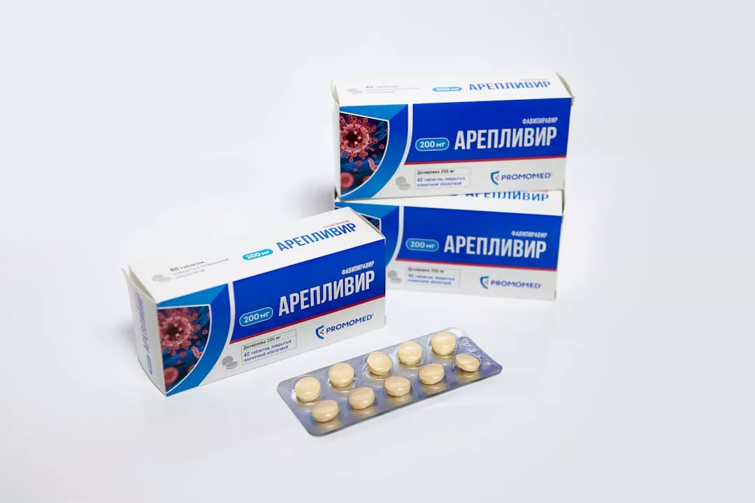 Three boxes of Areplivir tablets and a blister pack containing ten round cream-colored pills are displayed on a white surface, evoking an air of luxury in their presentation.